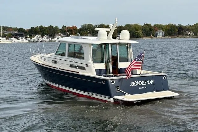 The Image of 2015 Sabre 42 Salon Express boat on water, rear view with American flag. - 0
