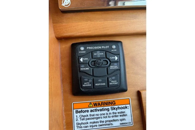 Slide: The Image of 2015 Sabre 42 Salon Express cruising on a calm lake with marina in background. - 21