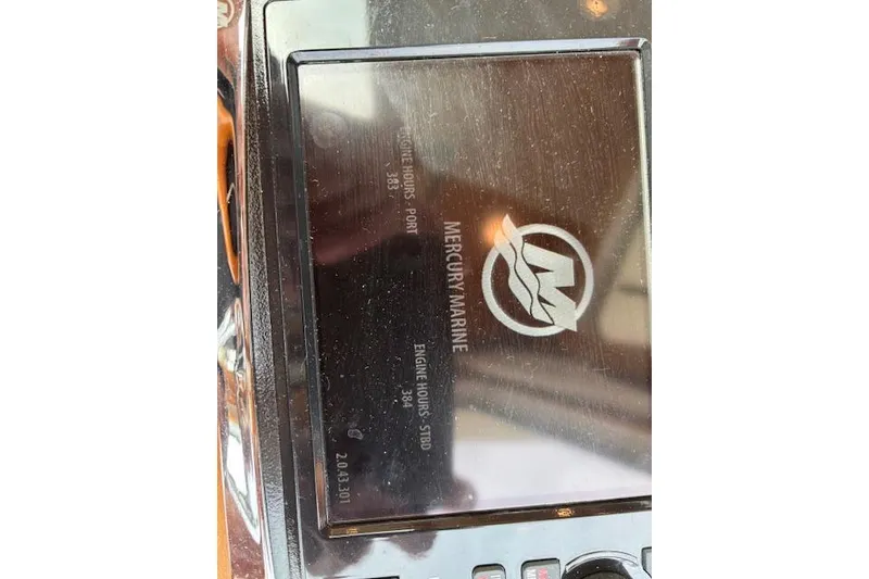 Slide: The Image of 2015 Sabre 42 Salon Express yacht cruising on calm waters with scenic shoreline backdrop. - 22