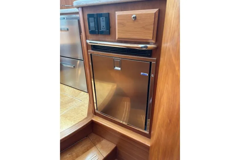 Slide: The Image of 2015 Sabre 42 Salon Express docked at marina, rear view with American flag. - 25