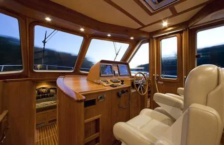 Slide: The Image of 2015 Sabre 42 Salon Express cabin with wooden interior and cozy bed. - 6
