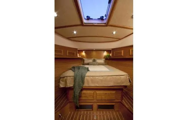 Slide: The Image of 2015 Sabre 42 Salon Express yacht with striped seating and wooden table on deck. - 9