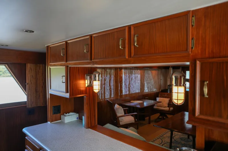 Slide: The Image of Side deck view of 1980 Hatteras 70 Motor Yacht on calm waters. - 15