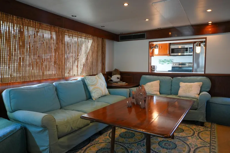 Slide: The Image of Spacious deck of 1980 Hatteras 70 Motor Yacht with seating and American flag. - 19