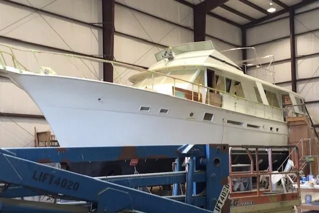 Slide: The Image of Interior of 1980 Hatteras 70 Motor Yacht with wooden decor and nautical-themed cushions. - 2