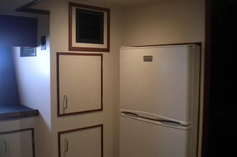 Slide: The Image of Cozy cabin with bunk beds in 1980 Hatteras 70 Motor Yacht, featuring wood paneling. - 23