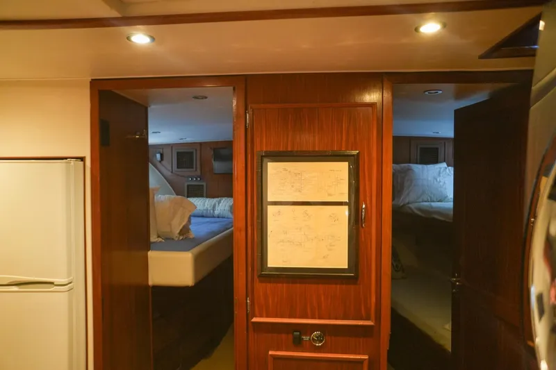Slide: The Image of Bunk beds in 1980 Hatteras 70 Motor Yacht cabin with wooden accents and porthole windows. - 26