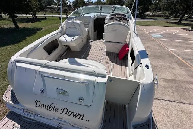 Slide: The Image of 2001 Sea Ray 245 Weekender boat, named "Double Down," docked on a sunny day. - 10