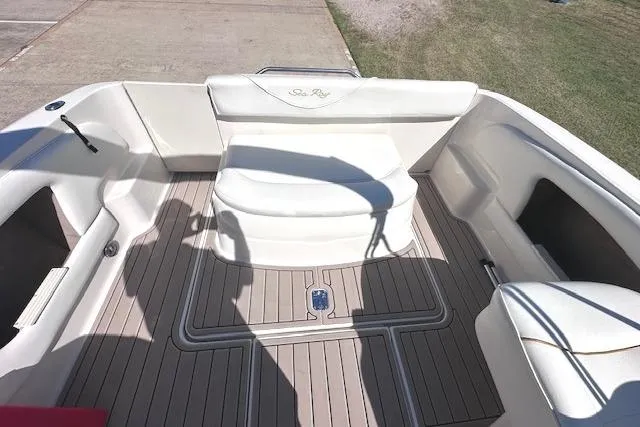 Slide: The Image of 2001 Sea Ray 245 Weekender boat interior with white seating and teak flooring. - 14