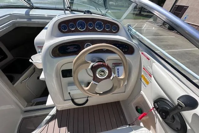 Slide: The Image of 2001 Sea Ray 245 Weekender boat helm with steering wheel and instrument panel. - 15