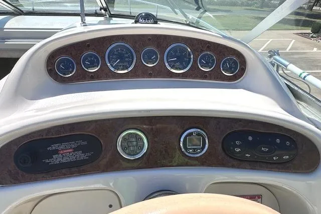 Slide: The Image of Dashboard of a 2001 Sea Ray 245 Weekender boat with gauges and controls. - 18