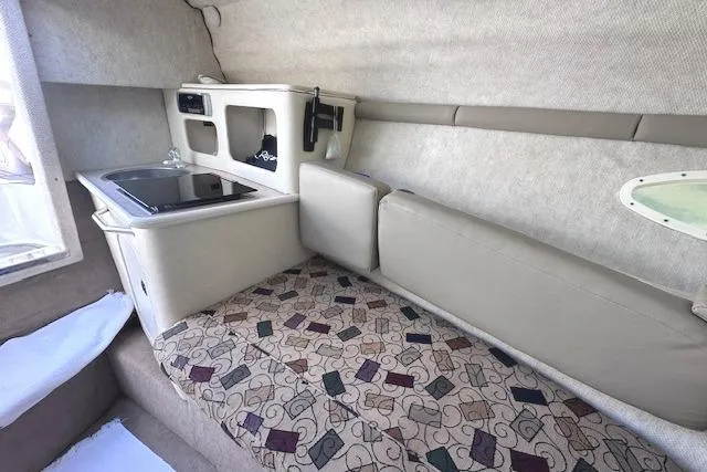 Slide: The Image of Interior of 2001 Sea Ray 245 Weekender boat with kitchenette and seating area. - 24