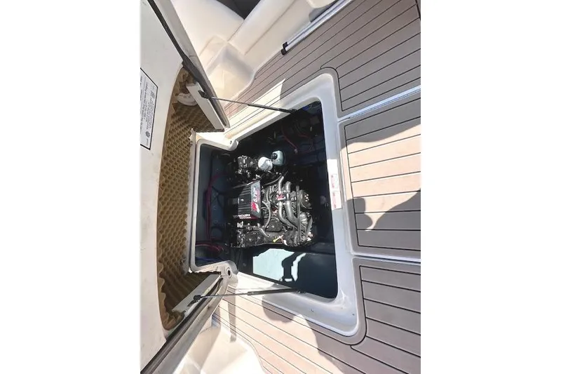 Slide: The Image of Engine compartment of a 2001 Sea Ray 245 Weekender boat, showcasing the engine details. - 30