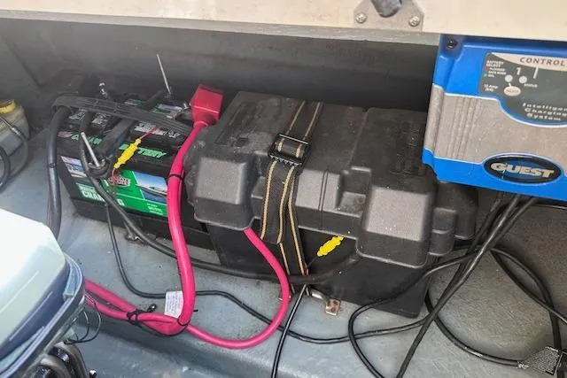 Slide: The Image of Battery compartment of a 2001 Sea Ray 245 Weekender boat with wiring and control panel. - 32