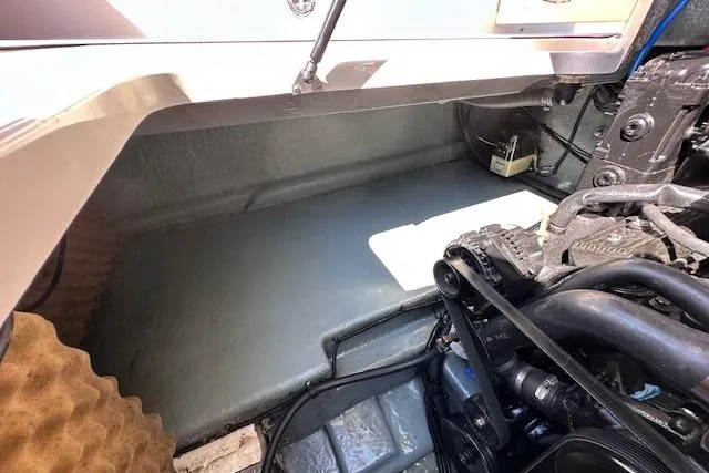 Slide: The Image of Engine compartment of a 2001 Sea Ray 245 Weekender boat, showcasing mechanical components. - 34