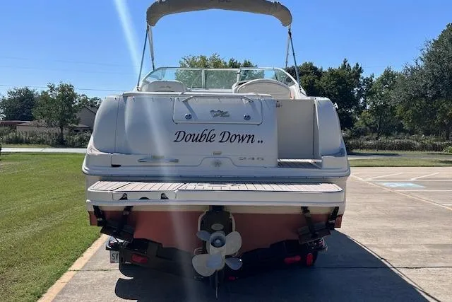 Slide: The Image of 2001 Sea Ray 245 Weekender boat named "Double Down" parked on a sunny day. - 4