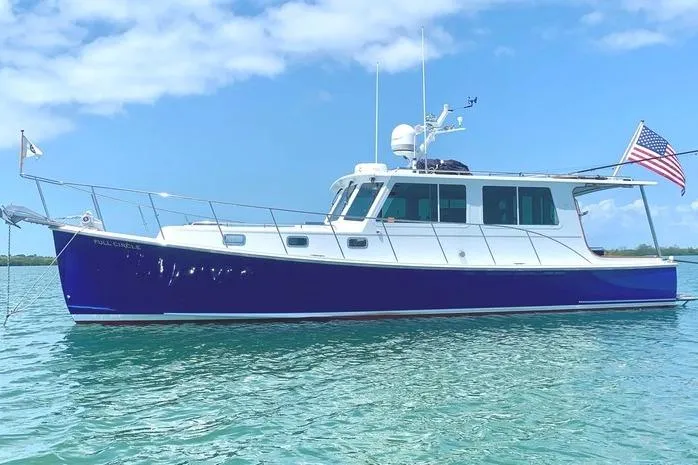 The Image of 2006 Duffy 37 Downeast boat on clear blue water, American flag flying. - 0