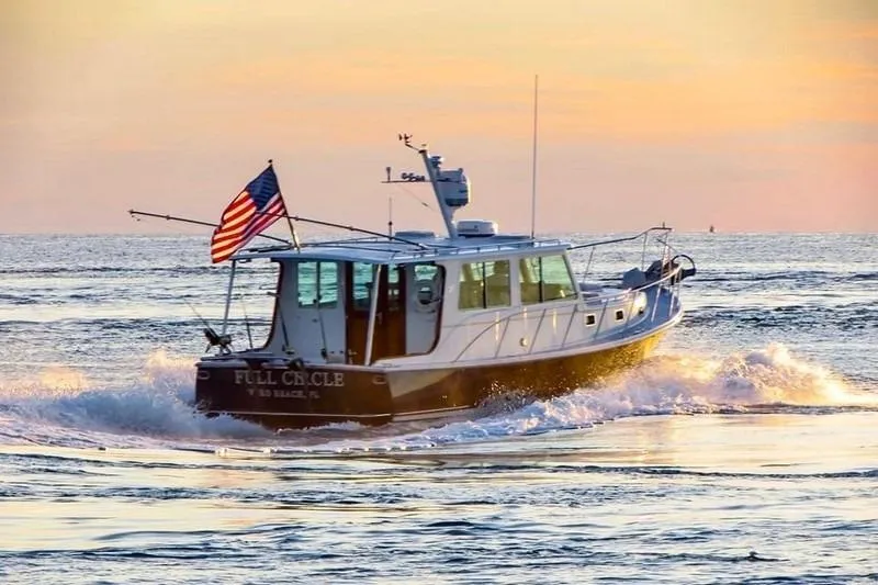 Slide: The Image of 2006 Duffy 37 Downeast boat cruising at sunset with American flag. - 11