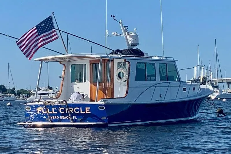 Slide: The Image of 2006 Duffy 37 Downeast boat named "Full Circle" in Vero Beach, Florida, with American flag. - 2