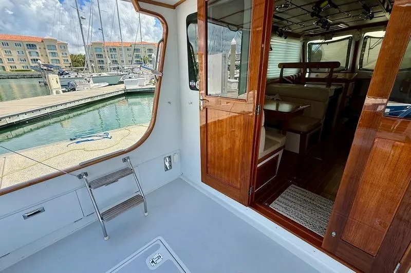 Slide: The Image of 2006 Duffy 37 Downeast boat interior with wooden doors, docked at marina. - 27