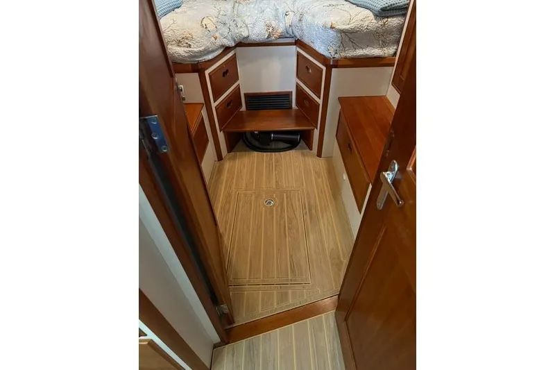 Slide: The Image of 2006 Duffy 37 Downeast cabin interior with wood flooring and storage drawers. - 28