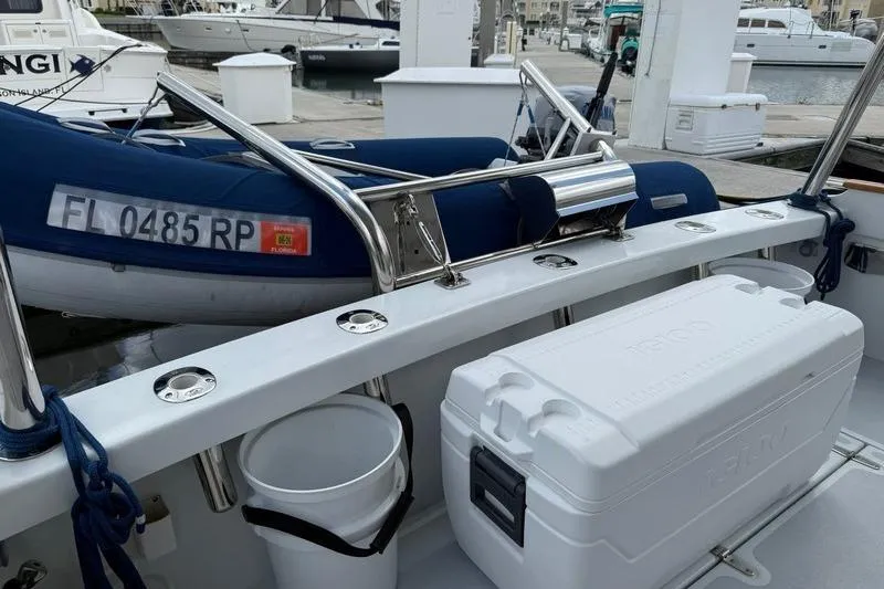 Slide: The Image of 2006 Duffy 37 Downeast boat deck with cooler and docked inflatable boat. - 31