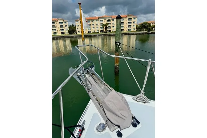 Slide: The Image of Bow of 2006 Duffy 37 Downeast boat docked near waterfront buildings. - 32