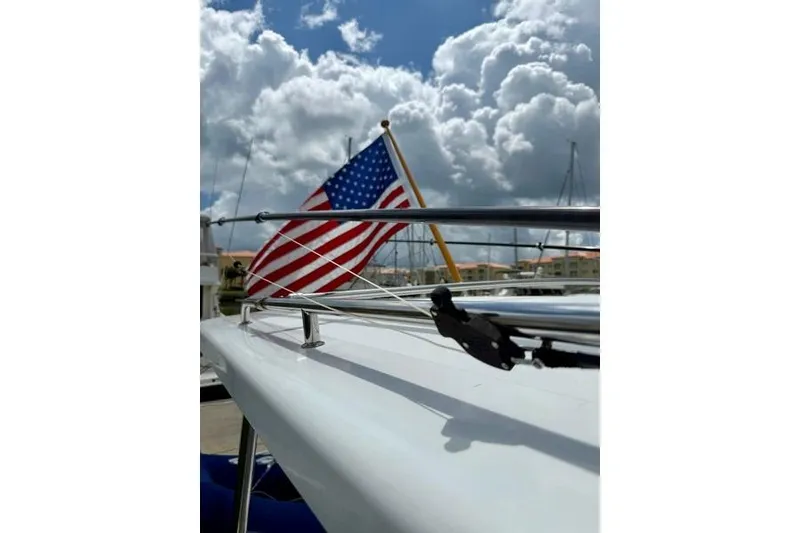 Slide: The Image of 2006 Duffy 37 Downeast boat with American flag under cloudy sky. - 35