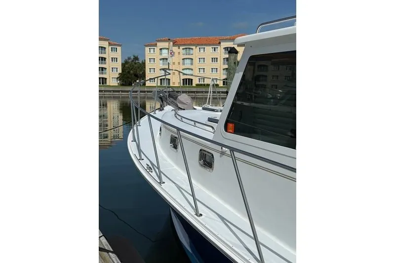 Slide: The Image of 2006 Duffy 37 Downeast boat docked near waterfront buildings. - 37