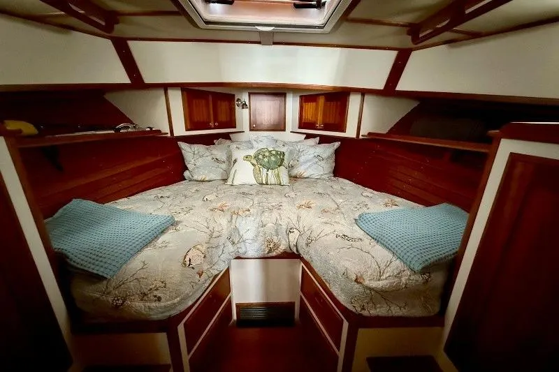 Slide: The Image of Cozy cabin interior of 2006 Duffy 37 Downeast boat with elegant bedding and wood accents. - 40