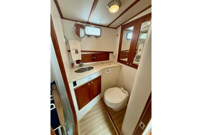 Slide: The Image of 2006 Duffy 37 Downeast boat bathroom with wood accents and modern fixtures. - 45