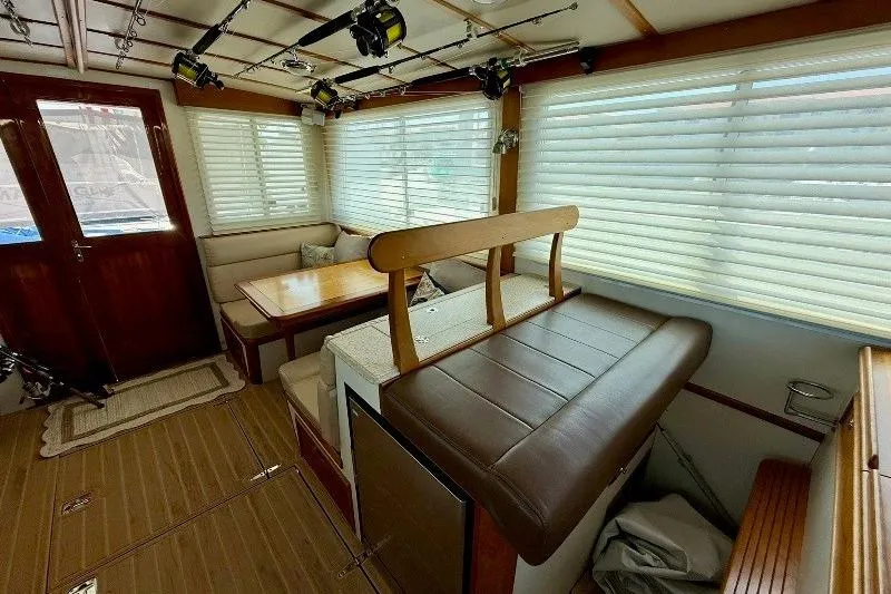 Slide: The Image of Interior of a 2006 Duffy 37 Downeast boat with seating and fishing rods. - 47