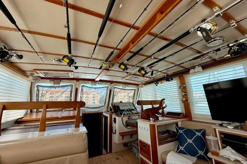 Slide: The Image of Interior of 2006 Duffy 37 Downeast boat with fishing rods and cozy seating. - 50