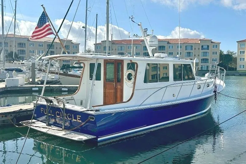 Slide: The Image of 2006 Duffy 37 Downeast boat docked in marina with American flag. - 6