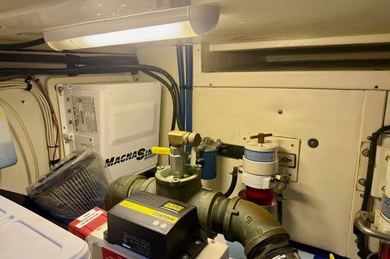 Slide: The Image of Engine room of a 2006 Duffy 37 Downeast boat, featuring mechanical components and wiring. - 60