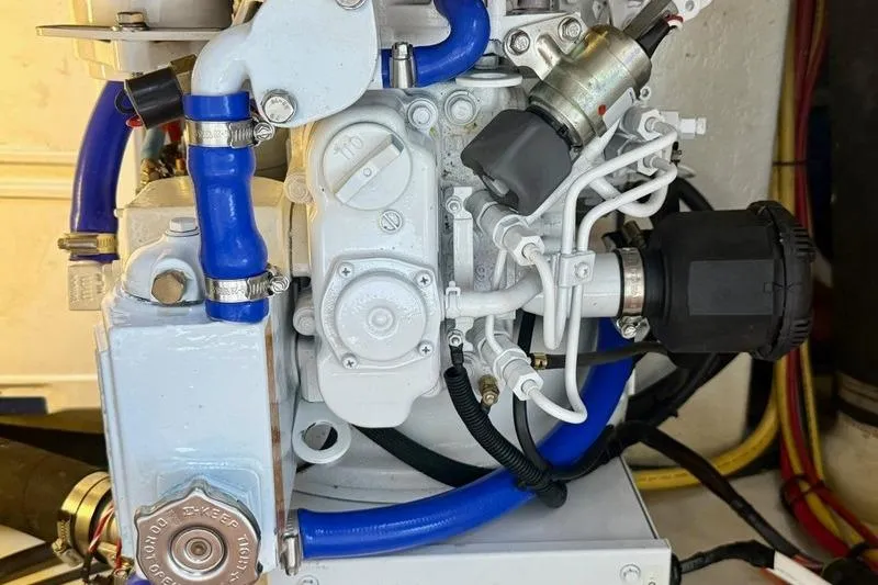 Slide: The Image of Engine components of a 2006 Duffy 37 Downeast boat with blue hoses and wiring. - 61