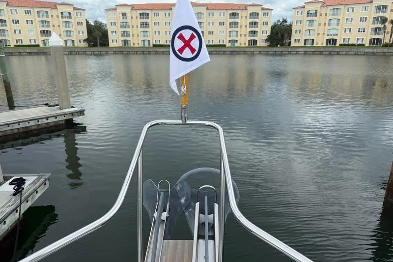 Slide: The Image of Bow of 2006 Duffy 37 Downeast boat with flag, docked near waterfront buildings. - 69