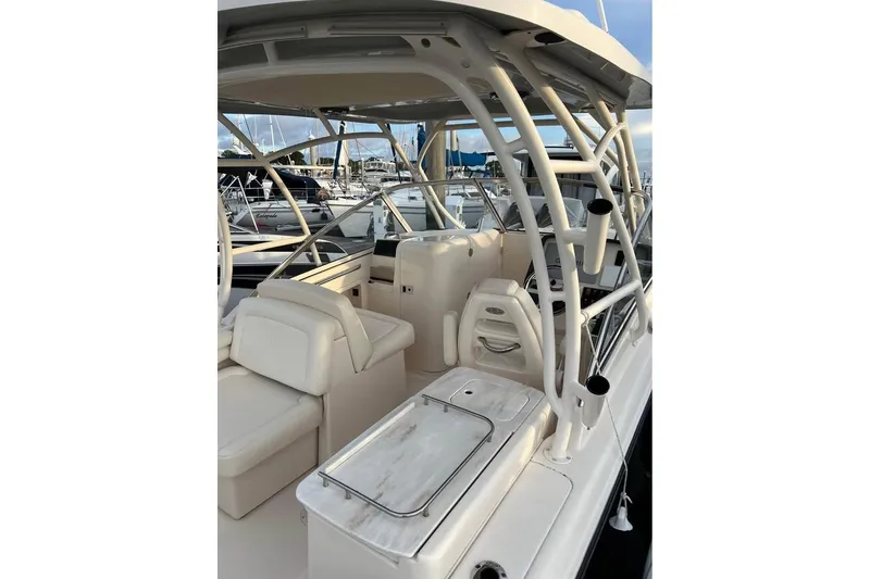 Slide: The Image of 2020 Grady-White Freedom 285 boat interior with seating and helm, docked at marina. - 10