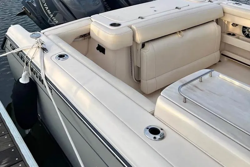 Slide: The Image of 2020 Grady-White Freedom 285 boat interior with beige seating and deck details. - 11