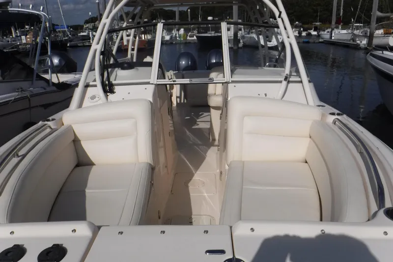 Slide: The Image of 2020 Grady-White Freedom 285 boat interior with white seating at a marina. - 13