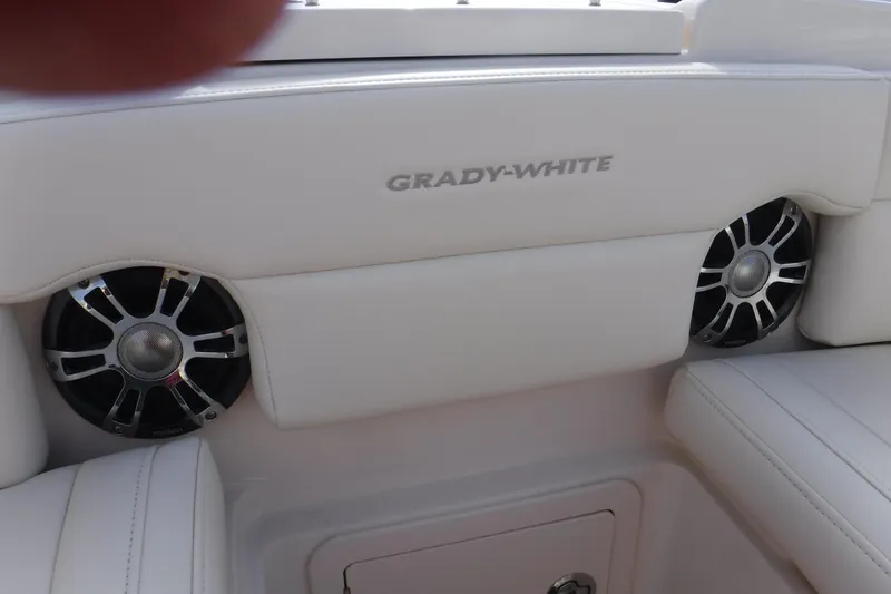 Slide: The Image of 2020 Grady-White Freedom 285 boat interior with speakers and white seating. - 18