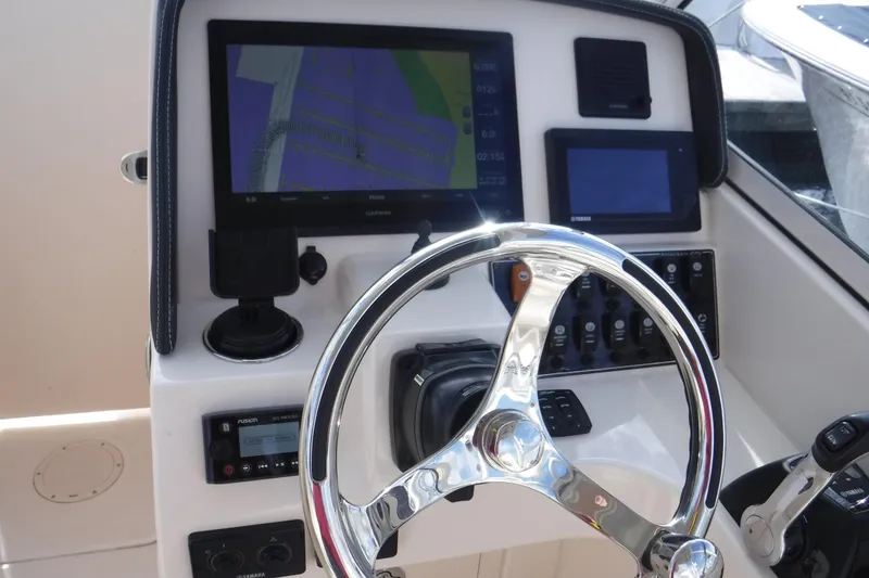 Slide: The Image of 2020 Grady-White Freedom 285 helm with steering wheel and navigation displays. - 2