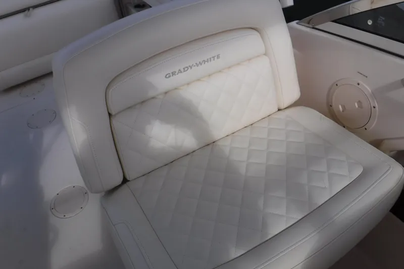 Slide: The Image of 2020 Grady-White Freedom 285 boat seat with quilted white upholstery. - 28