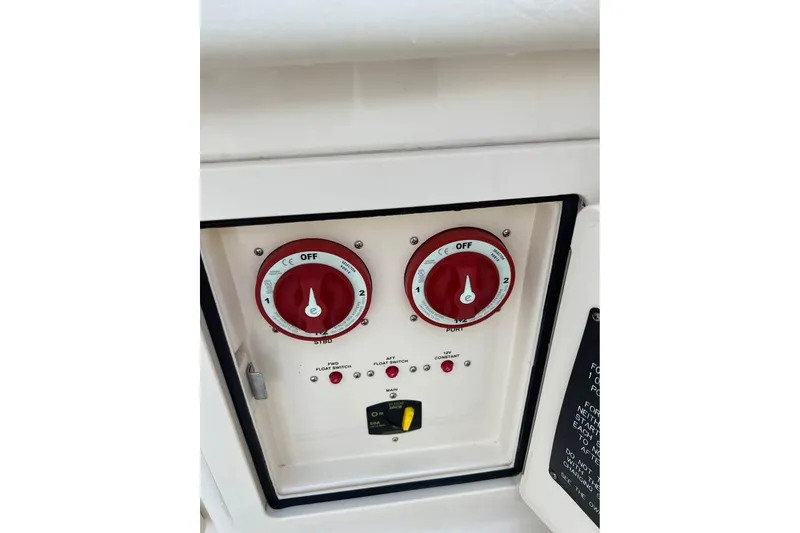 Slide: The Image of Control panel of 2020 Grady-White Freedom 285 boat with red dials and switches. - 6