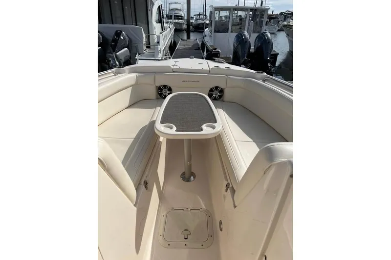 Slide: The Image of 2020 Grady-White Freedom 285 boat interior with seating and table, docked at marina. - 7