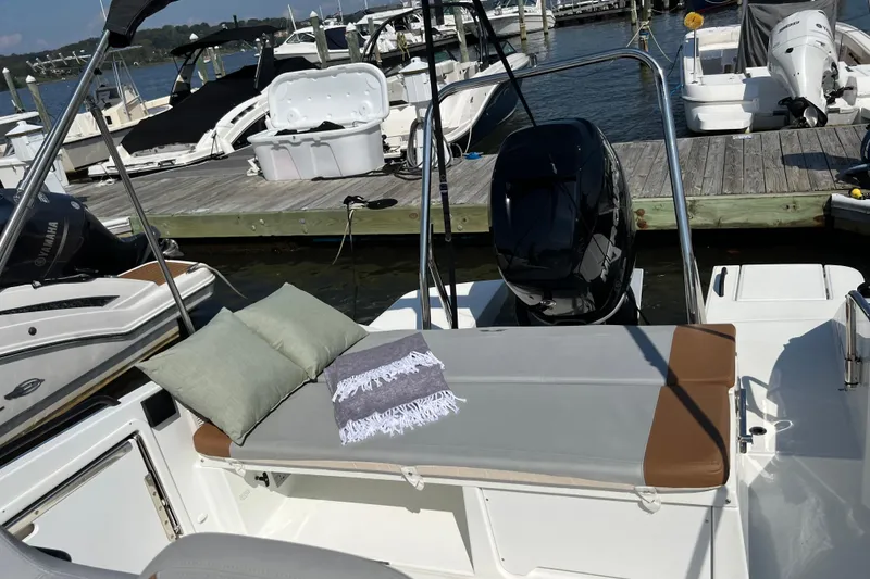 Slide: The Image of 2022 Beneteau Flyer 8 SUNdeck at marina, featuring sunbed and outboard motor. - 12