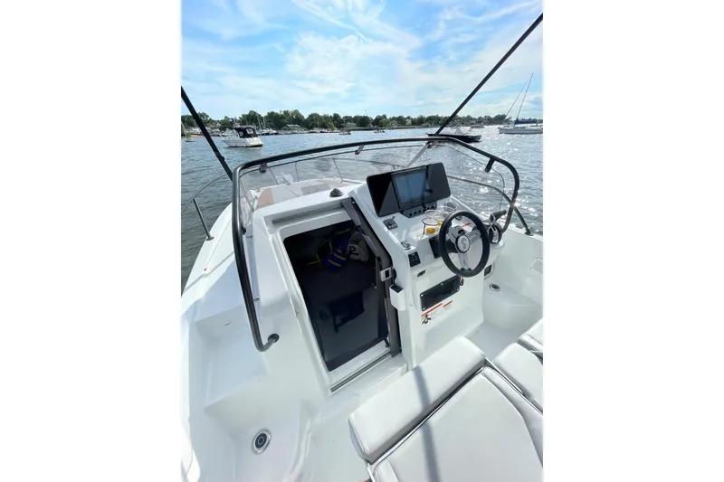 Slide: The Image of 2022 Beneteau Flyer 8 SUNdeck boat cockpit with steering wheel and navigation display. - 14