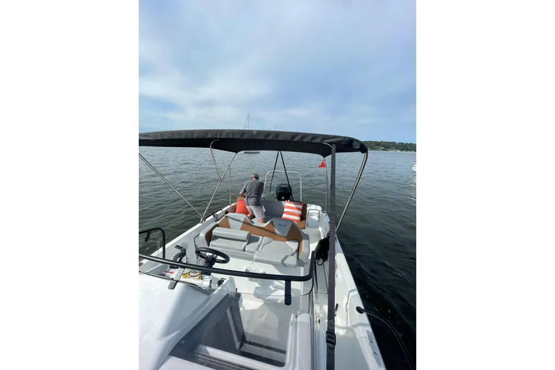 Slide: The Image of 2022 Beneteau Flyer 8 SUNdeck boat on calm water, featuring a shaded deck area. - 15