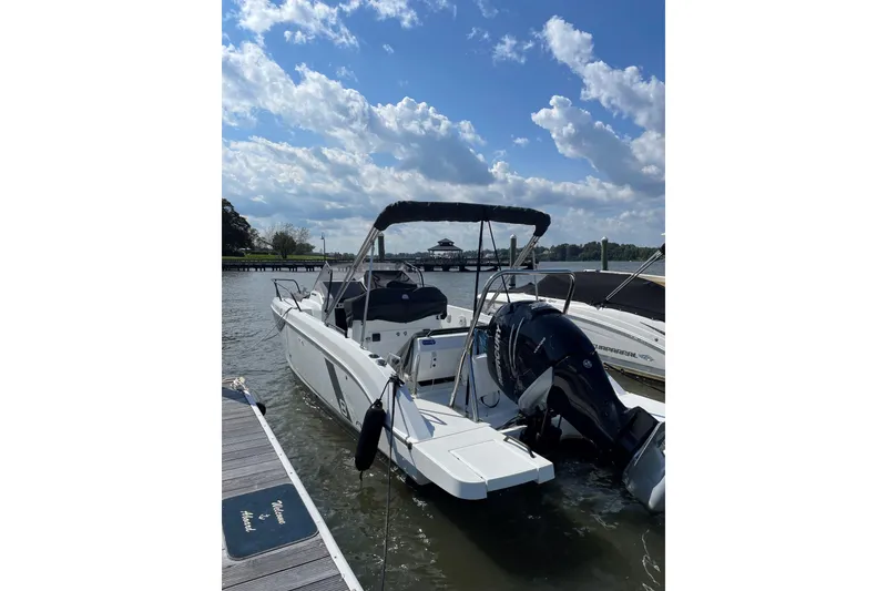 Slide: The Image of 2022 Beneteau Flyer 8 SUNdeck docked, featuring sleek design and powerful outboard motor. - 16