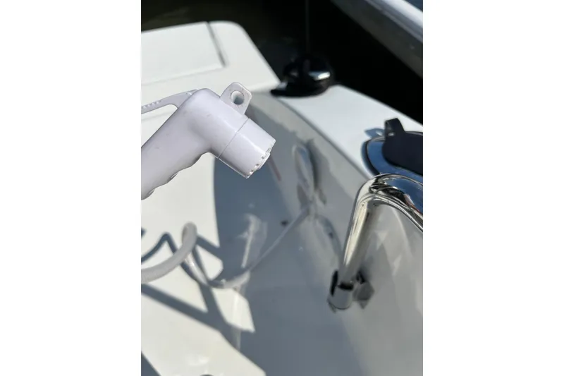 Slide: The Image of Close-up of a 2022 Beneteau Flyer 8 SUNdeck boat's deck with a white hose. - 22